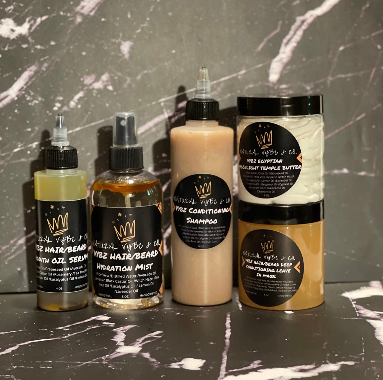 natural vybz conscious cosmetics hair collections with hair oil, hair mist, conditioning shampoo, butter, and conditioning mask