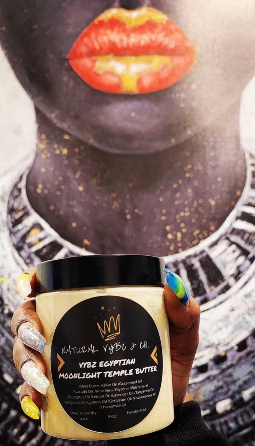 woman with designed nails holding up natural vybz temple butter